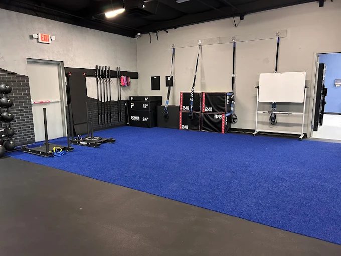 Turf lane with sleds, battle ropes, plyo boxes and suspension trainers