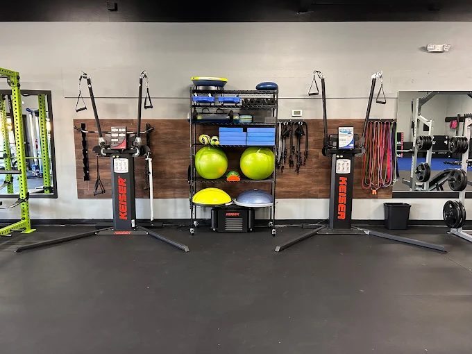 Functional training wall with Keiser cable machines, bands and stability balls